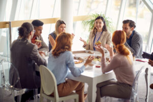 Group of young business people is enjoying a lunch break at the job; meal deduction
