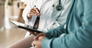 Tablet, hands and patient with doctor in hospital for consultation with health insurance deduction